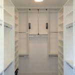 Custom-Closet-Build-with-White-Finish-Shelves-and-Silver-Hanger-Rods-750x750